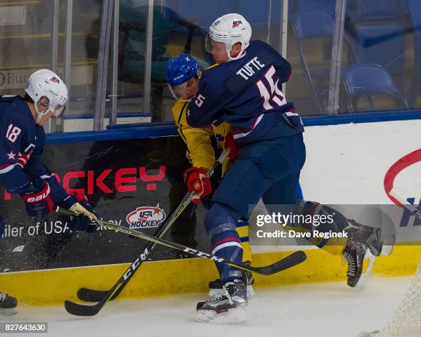 Riley Tufte of the USA body checks Gustav Lindstrom of Sweden during a World Jr. Summer Showcase game at USA Hockey Arena on August 2, 2017 in...