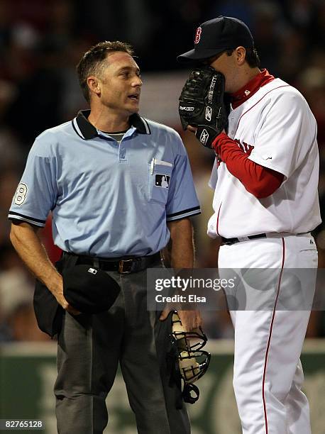 Josh Beckett of the Boston Red Sox talks with home plate umpire Dan Iassogna after the third inning against the Tampa Bay Ray at Fenway Park...