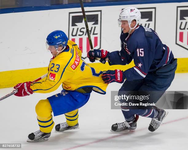 Riley Tufte of the USA grabs the jersey of Jesper Sellgren of Sweden during a World Jr. Summer Showcase game at USA Hockey Arena on August 2, 2017 in...