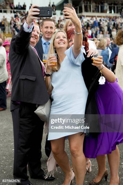 Racegoers taking 'selfies' in The Gordon Enclosure, 'Ladies Day' at "Glorious Goodwood" - The Qatar Goodwood Festival at Goodwood Racecourse, August...