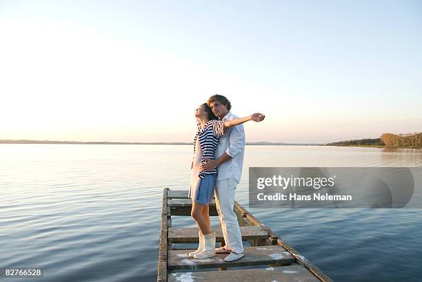 young couple flirting on a dock - montevideo photos et images de collection