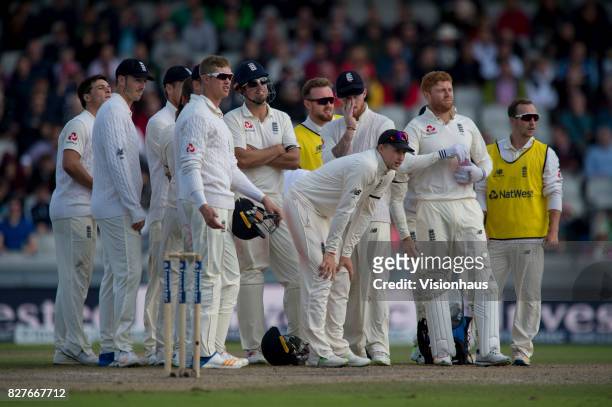 The England team wait for the decision of the third umpire after appealing for the wicket of Hasim Amla of South Africa during the fourth day of the...