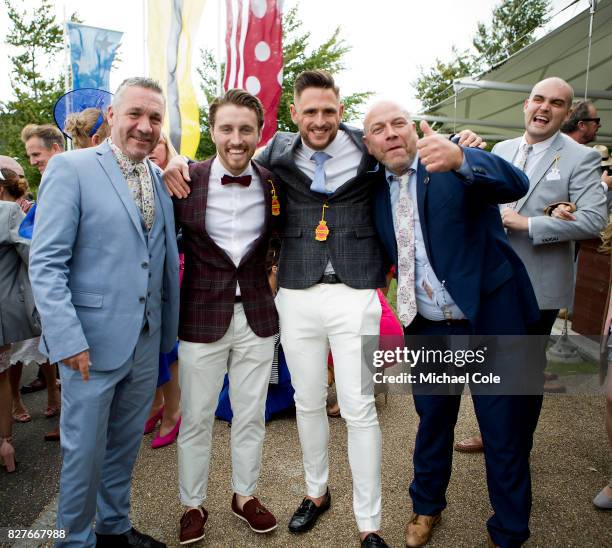 Four racegoers outside main entrance, 'Ladies Day' at "Glorious Goodwood" - The Qatar Goodwood Festival at Goodwood Racecourse, August 3, 2017 in...