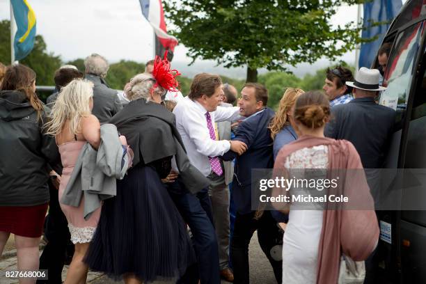 Confrontation as a result of 'queue jumping' for shuttle bus outside main entrance, 'Ladies Day' at "Glorious Goodwood" - The Qatar Goodwood Festival...