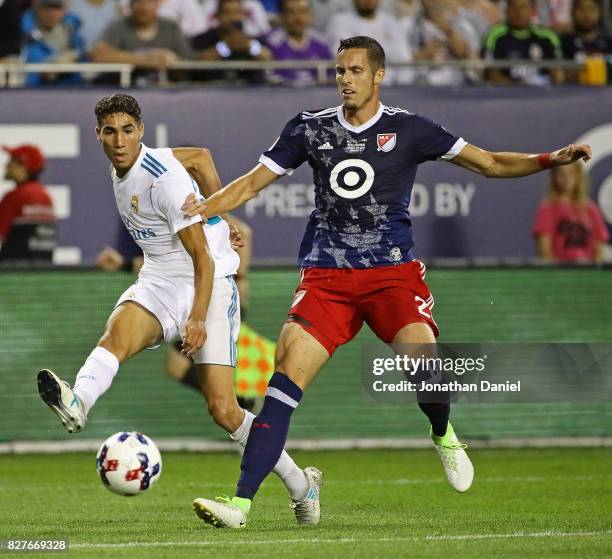 Achraf Hakimi of Real Madrid shoots around Matt Hedges of the MLS All-Stars during the 2017 MLS All- Star Game at Soldier Field on August 2, 2017 in...