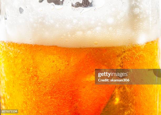 close up shot with foam beer of german dark beer inside beer mug - lager stock pictures, royalty-free photos & images