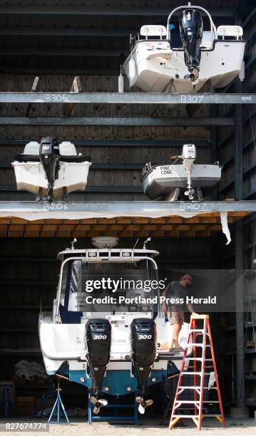 Dave Butler takes a break while installing stereo speakers on a Boston Whaler at York Harbor Marine.