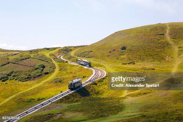great orme tramway moving across picturesque hills, llandudno, wales - llandudno stock pictures, royalty-free photos & images