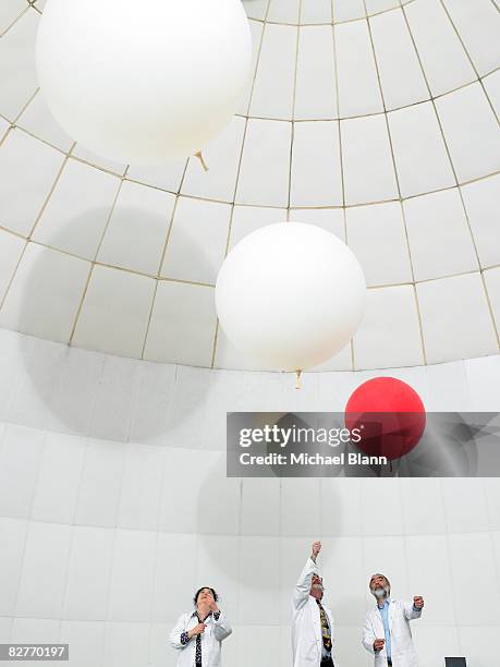 scientists watch weather ballons float upwards - red balloon stock pictures, royalty-free photos & images