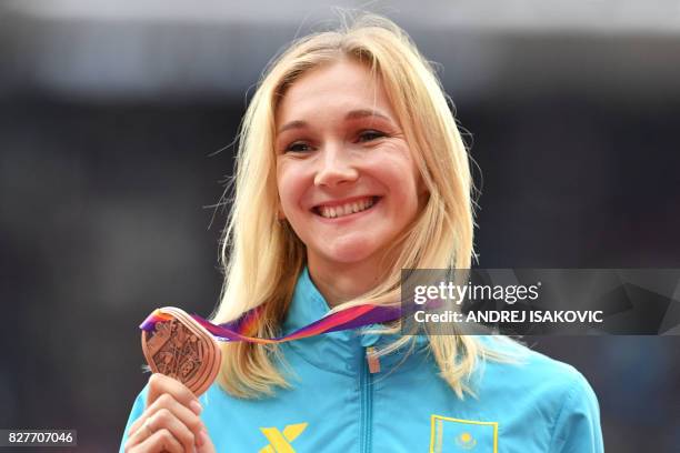 Bronze medallist Kazakhstan's Olga Rypakova poses on the podium during the victory ceremony for the women's triple jump athletics event at the 2017...