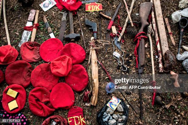 Weapons used by alleged attackers are displayed at police headquarters in Kinshasa on August 8 a day after twelve people were killed by stray gunfire...