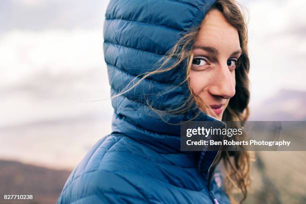 girl on windy mountain - jacket stock pictures, royalty-free photos & images