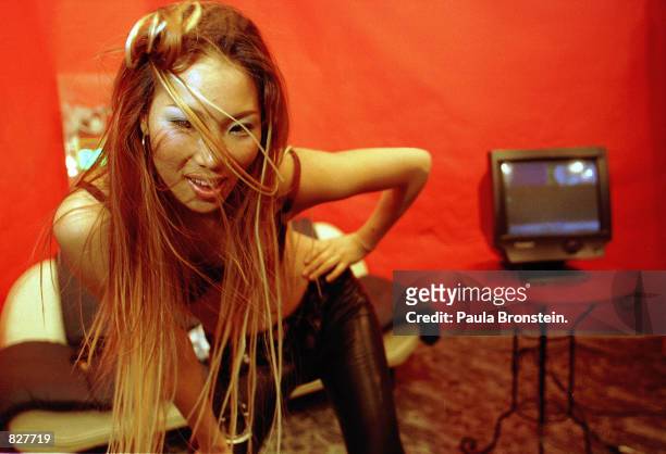 Ebony undresses in front of the digicam in the studio of Enterchannel in Seoul, South Korea, February 2000. She is featured live on the internet and...