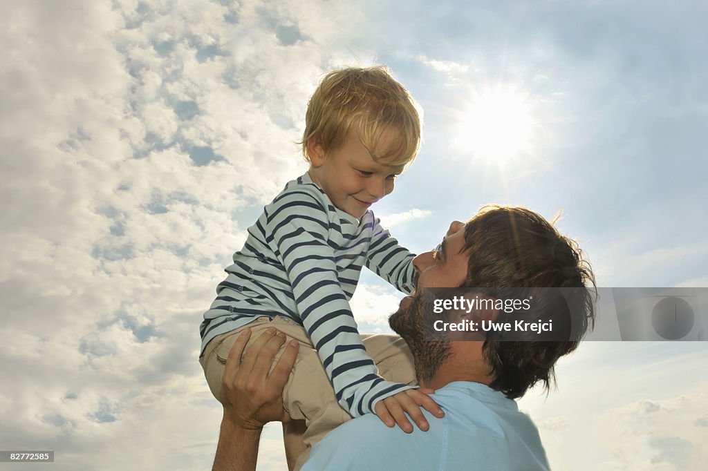 Father lifting son (5-6)