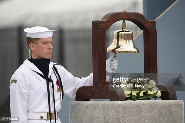 In this handout image provided by the U.S. Navy, A U.S. Navy Sailor rings a bell as the name of each person lost at the Pentagon is read during the...