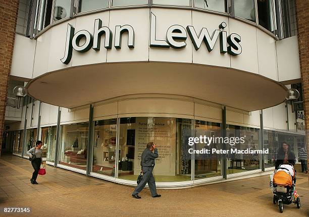 Shoppers pass a John Lewis store on September 11, 2008 in Kingston-Upon-Thames, England. John Lewis have stated that they face 'challenging'...