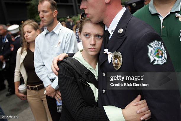 Amanda Platt hugs Jackson Mills, NJ firefighter Josh Lettera as the names are read of those who died in the September 11th terrorist attacks during...