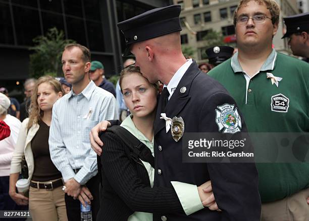 Amanda Platt hugs Jackson Mills, NJ firefighter Josh Lettera as the names are read of those who died in the September 11th terrorist attacks during...