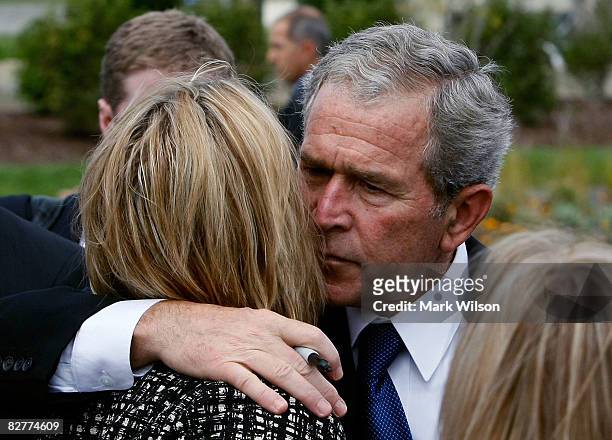 President George W. Bush hugs Stephanie Dunn DeSimone widow of Lt. Col. Patrick Dun who was kiiled at the Pentagon during the Pentagon Memorial...