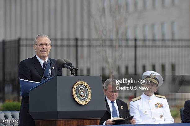 In this handout image provided by the U.S. Navy, Former Secretary of Defense Donald H. Rumsfeld speaks as President George W. Bush and Chairman of...