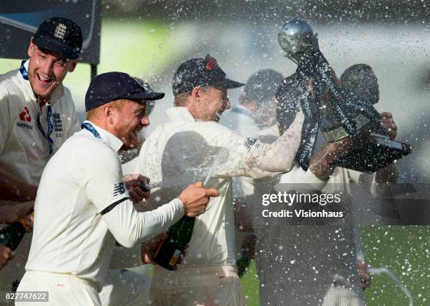 England captain Joe Root gets sprayed by champagne after the fourth day of the fourth test between England and South Africa at Old Trafford on August...