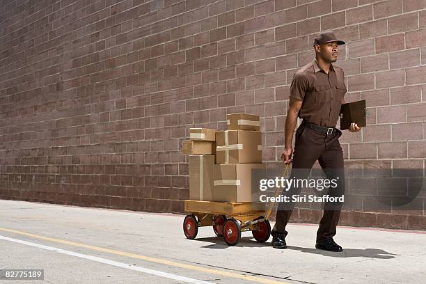 delivery-person carrying boxes on toy wagon - clipchart service occupation stock pictures, royalty-free photos & images