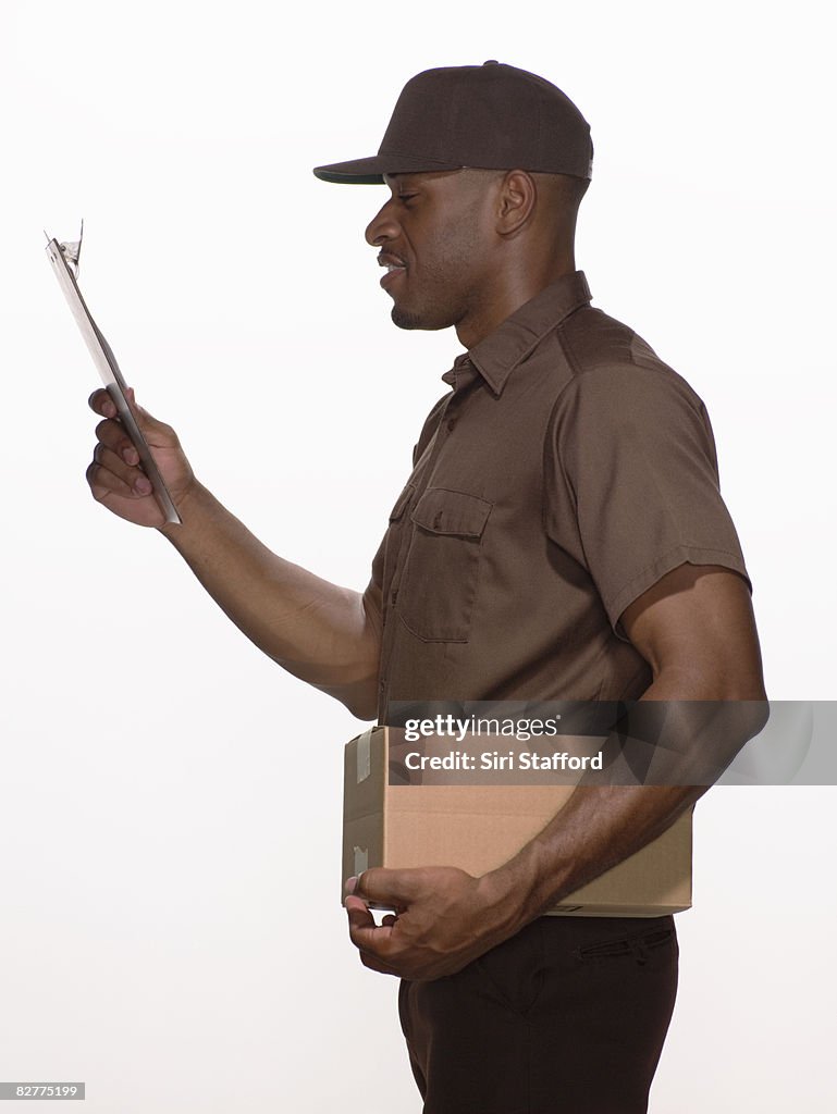 Delivery-person with box and clipboard