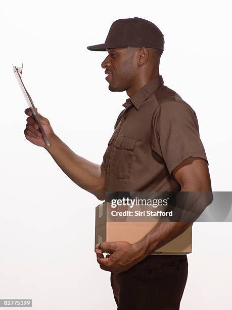 delivery-person with box and clipboard - delivery person on white stock pictures, royalty-free photos & images