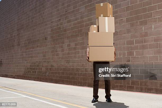 delivery-person carrying boxes - courier stockfoto's en -beelden