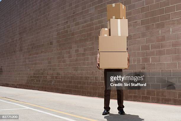 delivery-person carrying boxes - låda bildbanksfoton och bilder