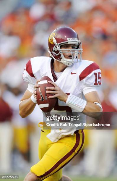 Aaron Corp of the Southern California Trojans rolls out to pass against the Virginia Cavaliers during the game at Scott Stadium on August 30, 2008 in...