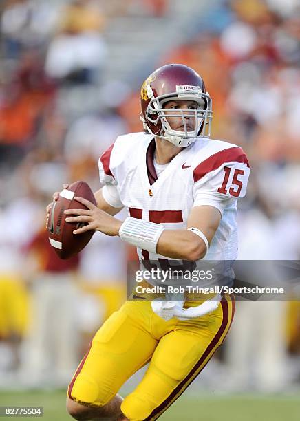 Aaron Corp of the Southern California Trojans rolls out to pass against the Virginia Cavaliers during the game at Scott Stadium on August 30, 2008 in...