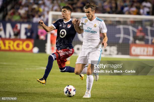 Gareth Bale of Real Madrid tangles it out with Miguel Almiron of the MLS All-Star team during the MLS All-Star match between the MLS All-Stars and...