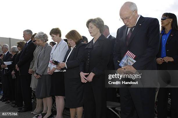 In this handout from the U.S. Department of Defence , Vice President Dick Cheney , first lady Laura Bush and other guests bow their heads during the...