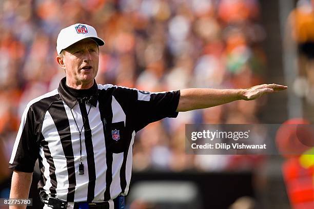 Referee Bill Carollo signals an infraction during the game between the Dallas Cowboys and the Cleveland Browns at Cleveland Browns Stadium on...