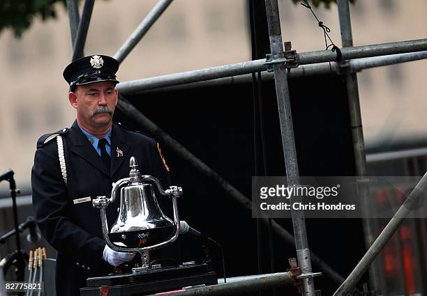 Firefighter stands by a bell after ringing it to mark the 9:03 am crash of United Airlines Flight 175 against the South Tower of the World Trade...