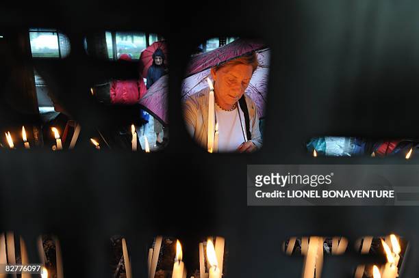 Pilgrims light candles near the Grotto of Massbielle at the Sanctuary of Lourdes on September 11, 2008 ahead of the visit of Pope Benedict XVI who...