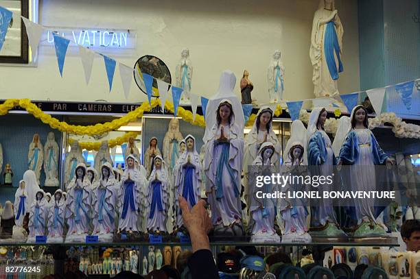 Statues of the Virgin Mary are displayed in a store in Lourdes on September 11, 2008 ahead of the visit of Pope Benedict XVI who will commemorate...