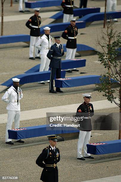 In this handout image provided by the U.S. Department of Defense, Joint service troops stand near benches during the Pentagon Memorial dedication...