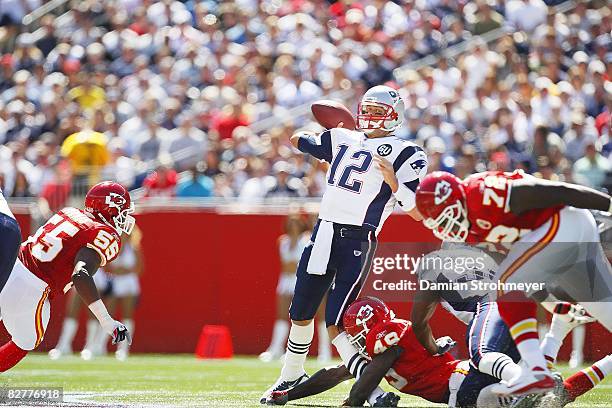 New England Patriots QB Tom Brady in action, making pass and receiving hit to left knee from Kansas City Chiefs Bernard Pollard . Brady sustained...