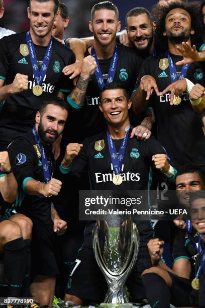 Cristiano Ronaldo of Real Madrid and his Real Madrid team mates celebrate with UEFA Super Cup trophy after the UEFA Super Cup final between Real...