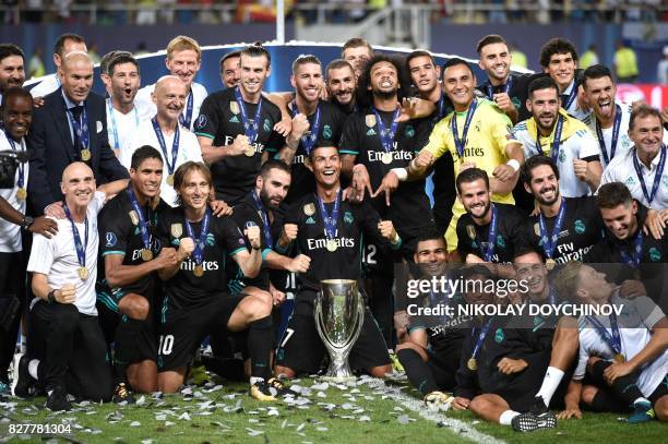 Madrid's players celebrate with the trophy after winning the UEFA Super Cup football match between Real Madrid and Manchester United on August 8 at...