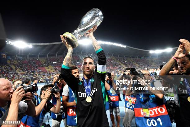 Real Madrid's Spanish defender Sergio Ramos holds the trophy after winning the UEFA Super Cup football match between Real Madrid and Manchester...