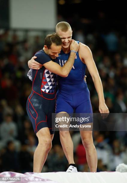 Sam Kendricks of the United States, gold, and Renaud Lavillenie of France, bronze, embrace as the compete in the Men's Pole Vault final during day...