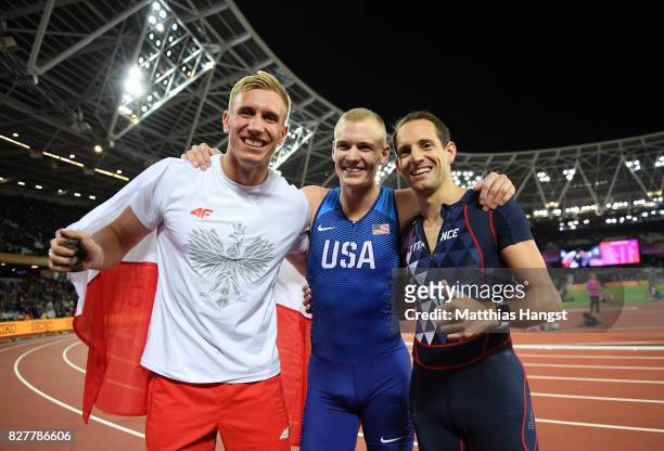 Piotr Lisek of Poland, silver, Sam Kendricks of the United States, gold, and Renaud Lavillenie of France, bronze, celebrate after the Men's Pole...