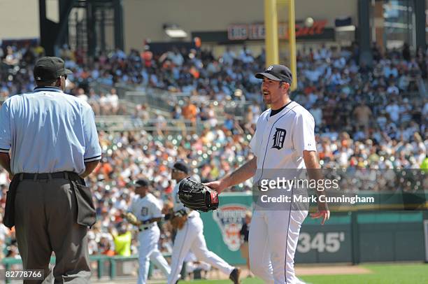 Justin Verlander of the Detroit Tigers talks to Major League Umpire Chuck Meriwether during the game against the New York Yankees at Comerica Park in...