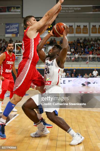 Yakuba Ouattara of France is trying to shoot the basket against Marko Tomas of Croatia during the international friendly game between France and...