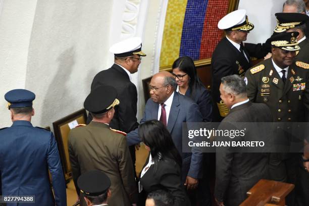 Venezuela's Constituent Assembly's president and vice-president, Delcy Rodriguez and Aristobulo Isturiz respectively, greet members of the military...