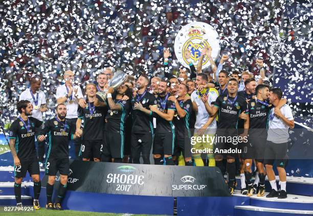 Football Players of Real Madrid raise the trophy after their victory at the end of the UEFA Super Cup final between Real Madrid and Manchester United...