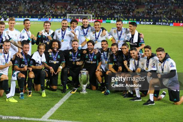 Football Players of Real Madrid pose for a photo with the trophy after their victory at the end of the UEFA Super Cup final between Real Madrid and...